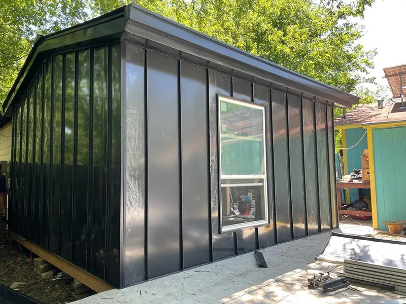 Black standing seam metal wall panels for Roof Inspection in Moorhead