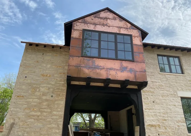 Copper metal panel facade on a stone building for Metal Roof Coating in Moorhead