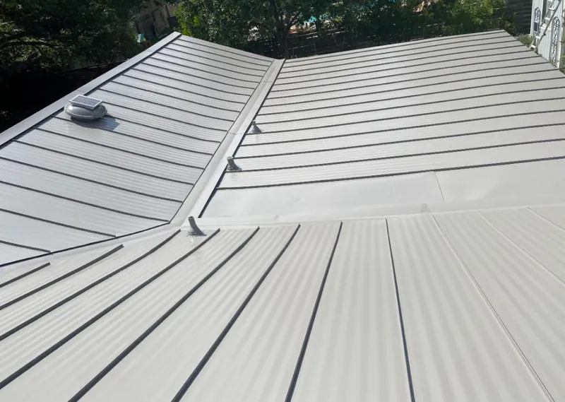 Solar attic fan installed on a metal roof for Roof Ventilation in Moorhead